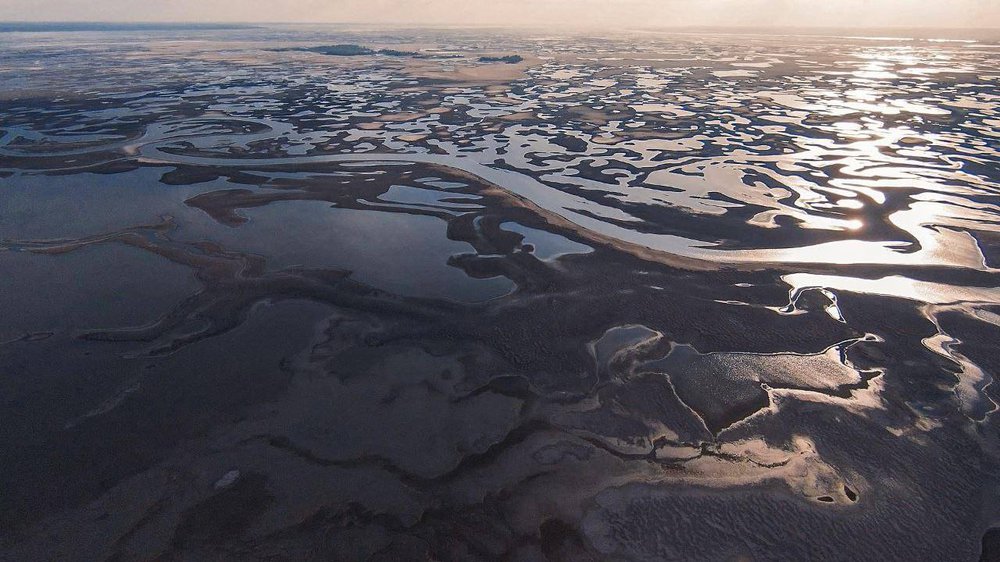 The bed of the Kakhovka Reservoir has nearly dried out after the dam was destroyed on 6 June 2023.