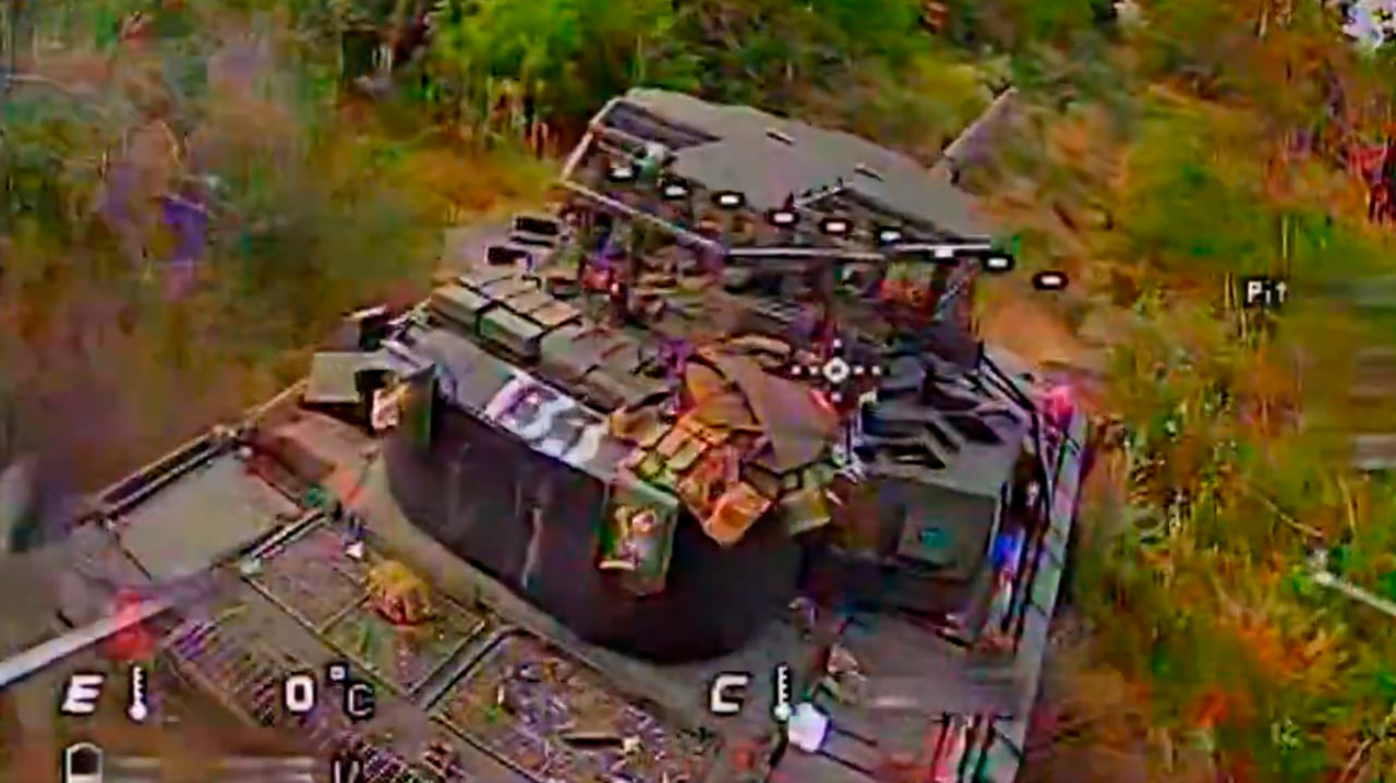 An Arena-M tank right before a drone strike.