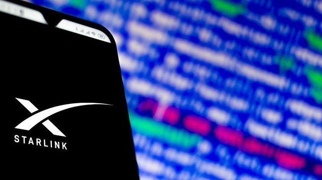 The Starlink logo on a smartphone screen.